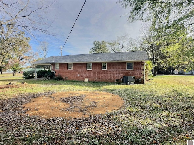 rear view of property with a lawn and cooling unit