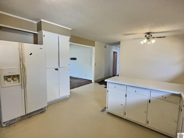 kitchen with white cabinets, ceiling fan, and white refrigerator with ice dispenser