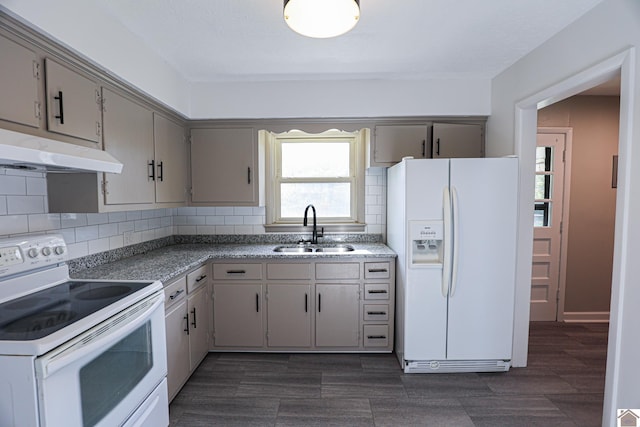 kitchen featuring gray cabinets, white appliances, a sink, and under cabinet range hood