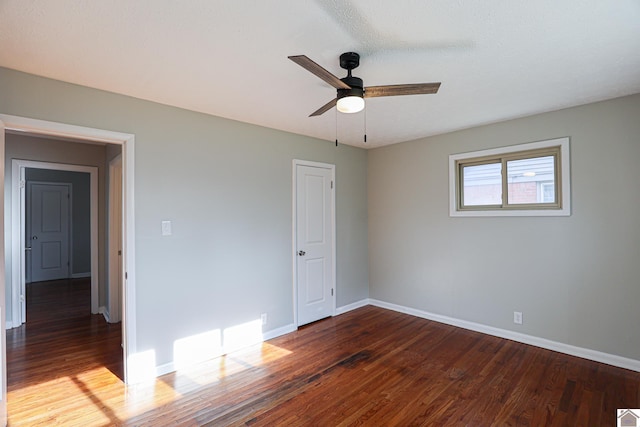 empty room featuring baseboards and wood finished floors