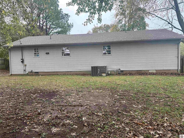 view of side of home with central AC unit