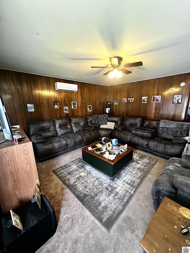 living room with carpet flooring, wood walls, and ceiling fan