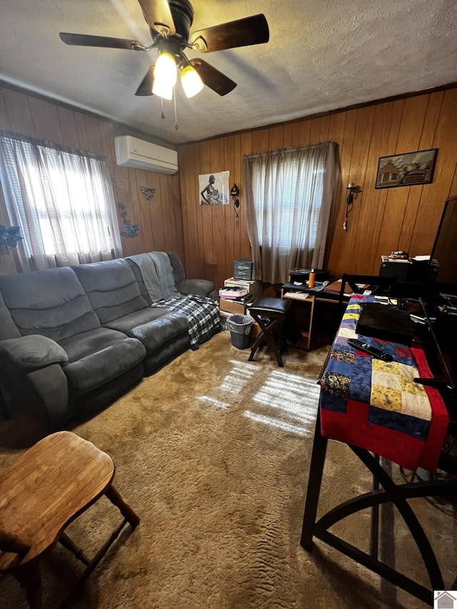 living room with a textured ceiling, carpet flooring, a wall unit AC, and wooden walls