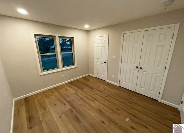 unfurnished bedroom with wood-type flooring