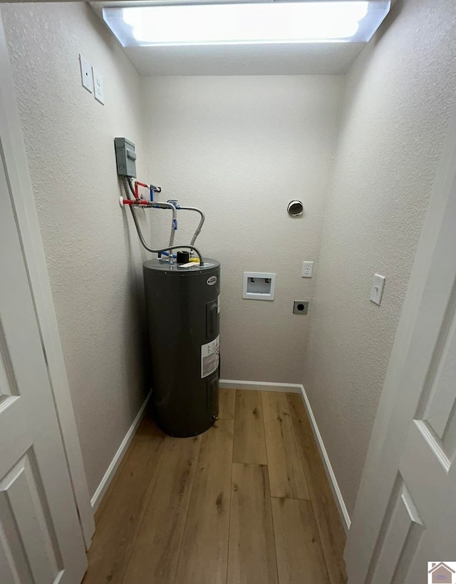 laundry room featuring washer hookup, water heater, light wood-type flooring, and electric dryer hookup