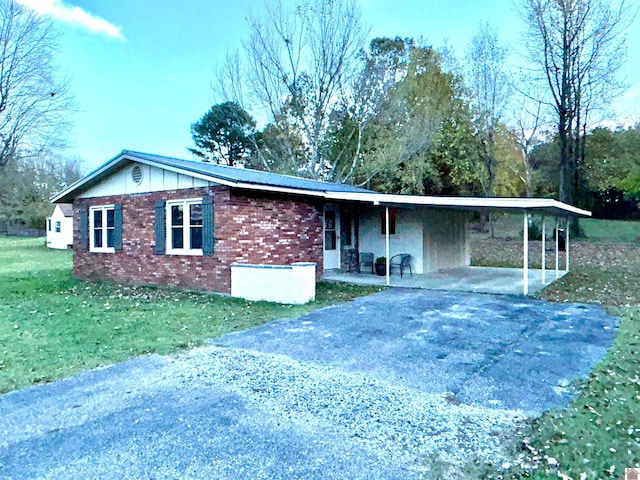 single story home with a carport and a front yard