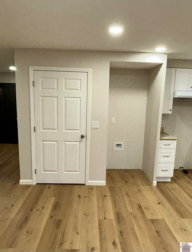 washroom with light hardwood / wood-style floors and washer hookup