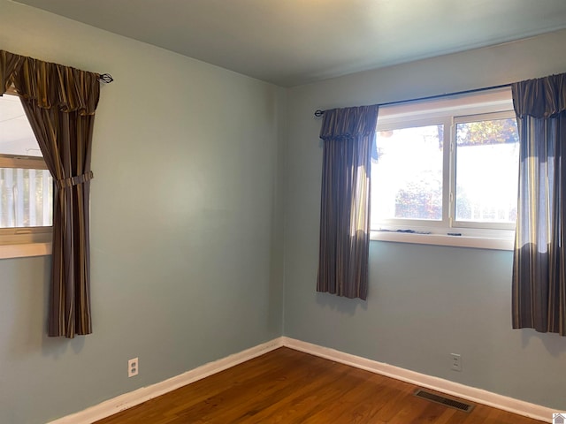 spare room with hardwood / wood-style floors