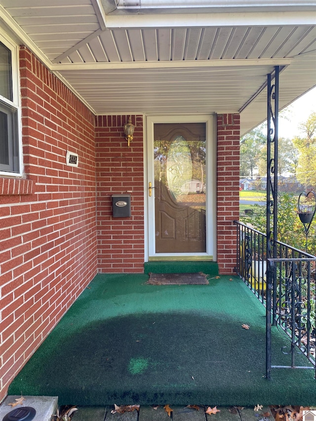 view of exterior entry with covered porch