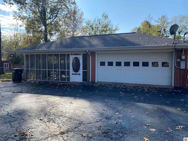 single story home with a garage and a sunroom