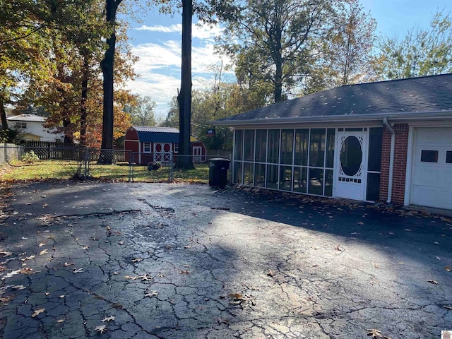 exterior space featuring a garage and a sunroom