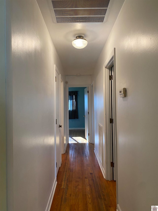 hallway with dark hardwood / wood-style floors