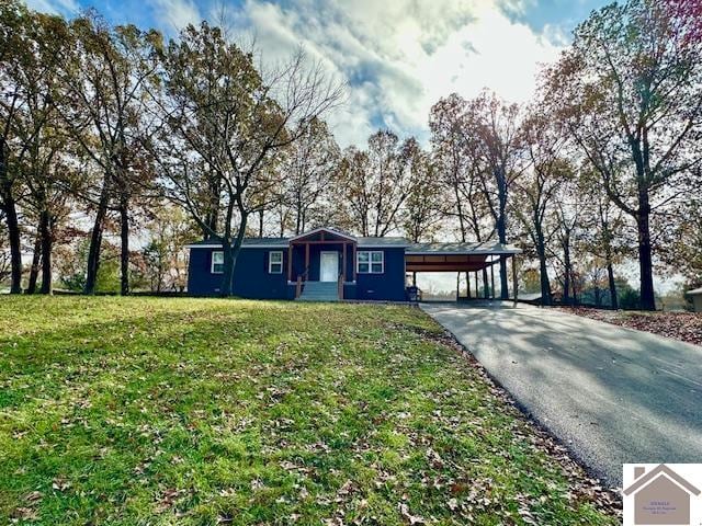 ranch-style home featuring a front yard and a carport