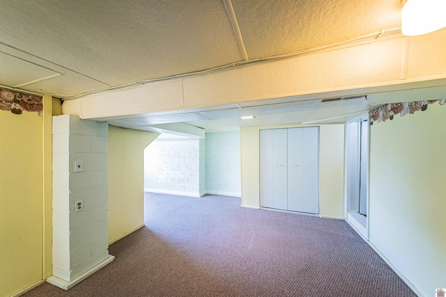 basement with carpet and a textured ceiling