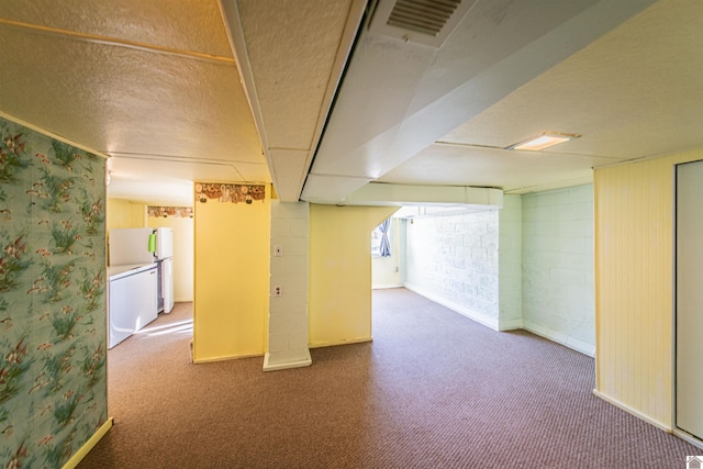 basement with carpet flooring and a textured ceiling