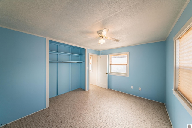 unfurnished bedroom featuring a textured ceiling and ceiling fan