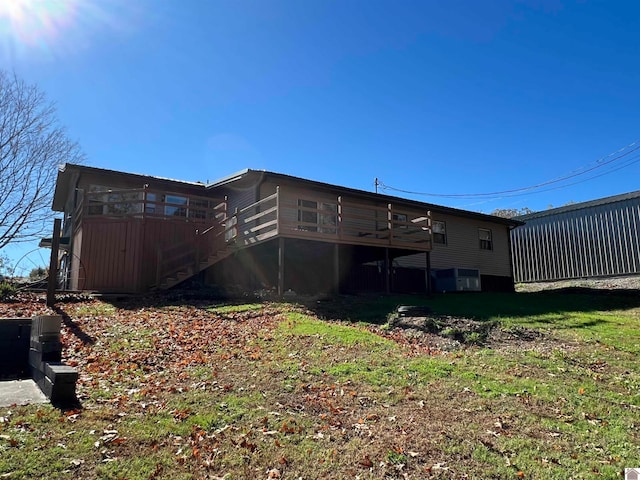 rear view of house featuring a deck