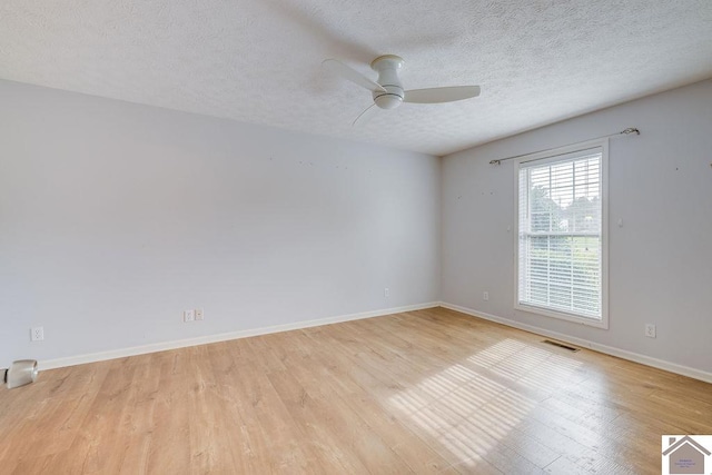 unfurnished room with light wood-type flooring, a textured ceiling, and ceiling fan