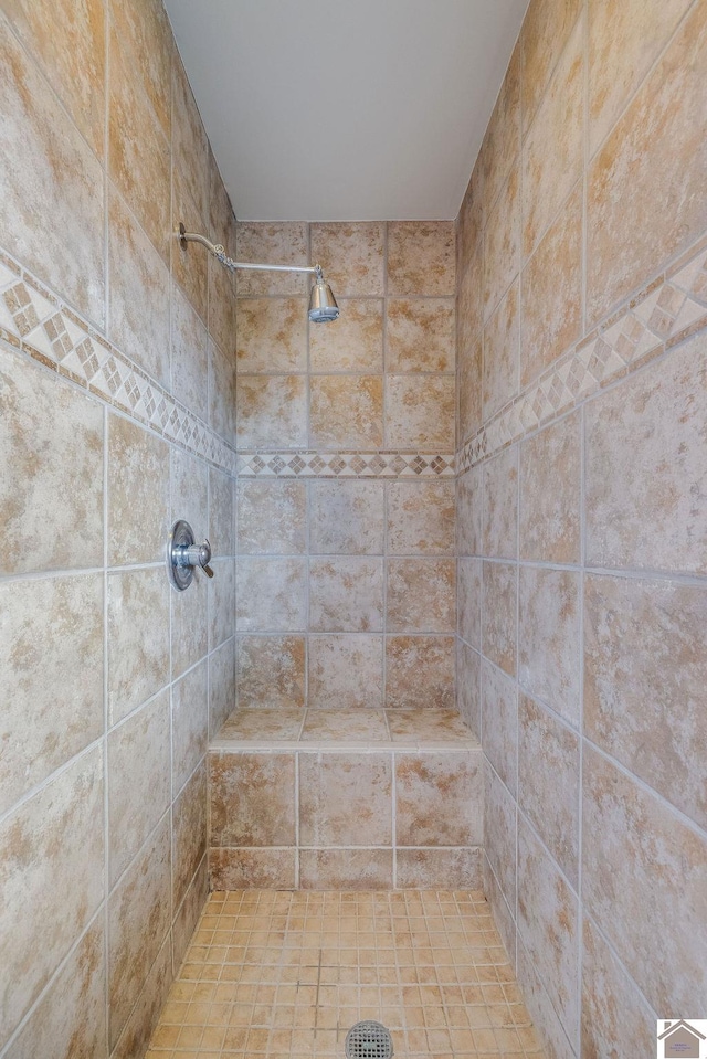 bathroom with a tile shower