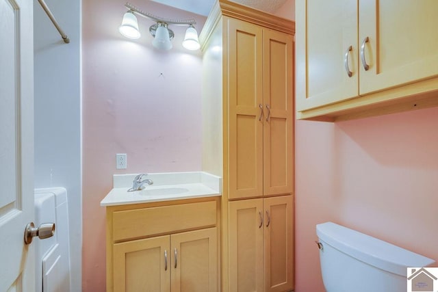 bathroom featuring toilet and vanity