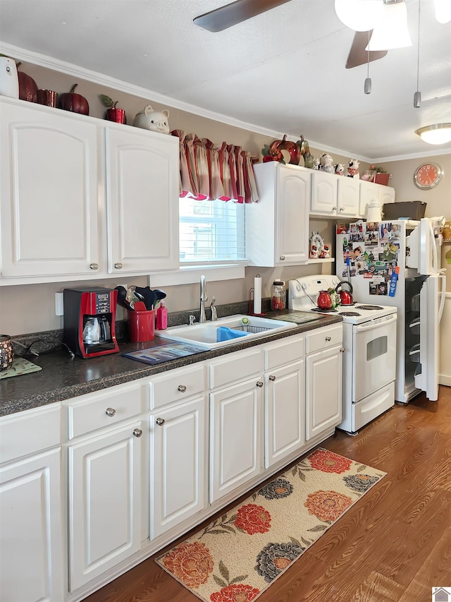 kitchen with dark hardwood / wood-style flooring, white cabinetry, electric stove, and sink