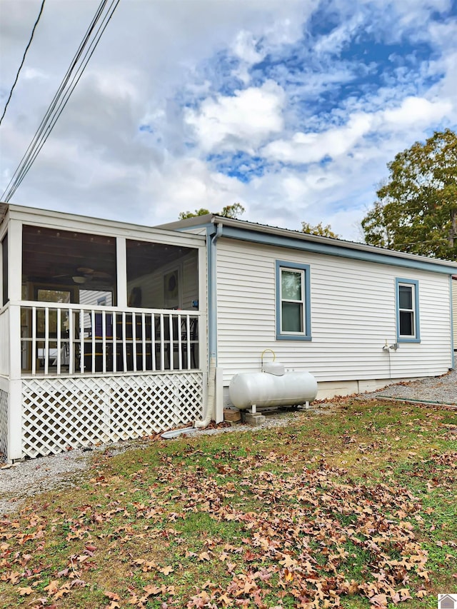 view of property exterior featuring a sunroom