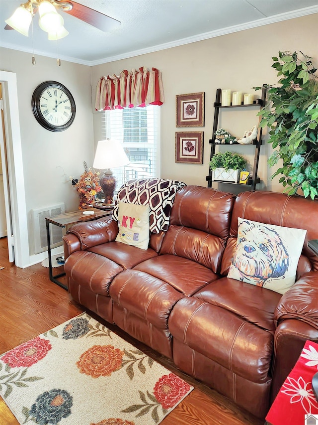 living room with wood-type flooring, ceiling fan, and crown molding