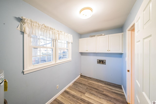 laundry area with cabinets, dark wood-type flooring, and hookup for a washing machine