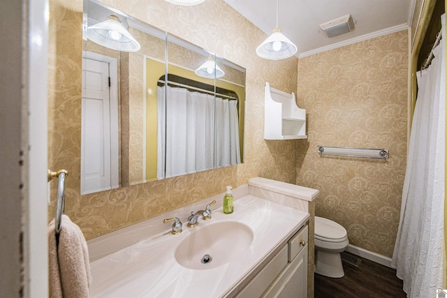 bathroom with toilet, vanity, hardwood / wood-style flooring, and ornamental molding