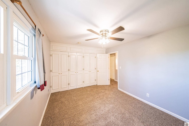 unfurnished bedroom featuring a closet, carpet flooring, and ceiling fan