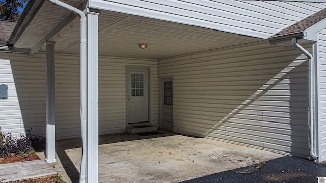 view of exterior entry with a carport