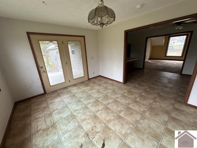 unfurnished dining area featuring an inviting chandelier