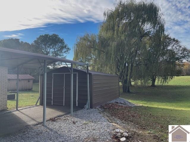 view of gate with a yard and a storage shed