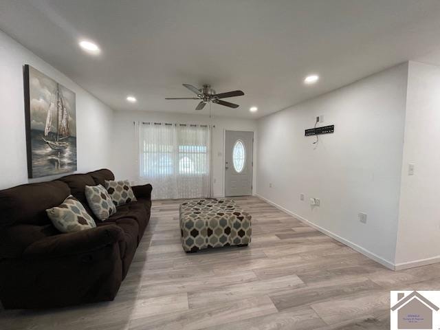 living room featuring light hardwood / wood-style floors and ceiling fan