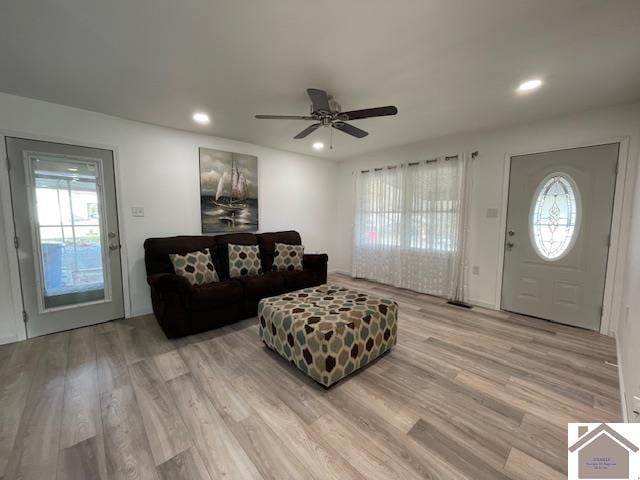 living room featuring ceiling fan and light hardwood / wood-style floors