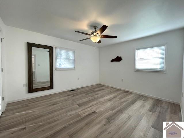 spare room featuring hardwood / wood-style floors and ceiling fan