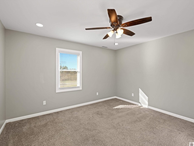 spare room with carpet flooring and ceiling fan