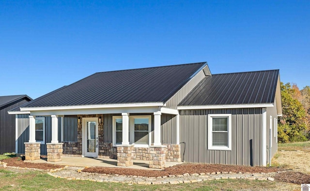 rear view of house featuring a porch