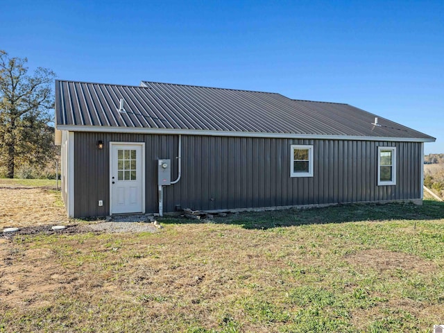 rear view of property with a lawn