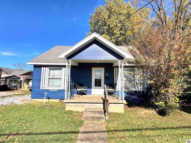 bungalow-style home featuring a front yard and covered porch