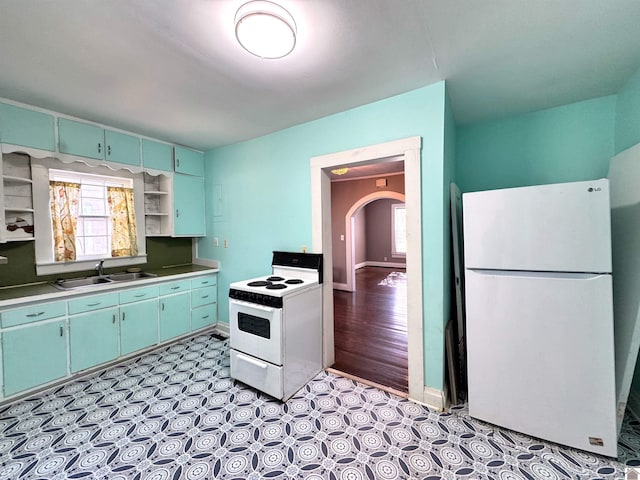 kitchen with white appliances, sink, and light hardwood / wood-style flooring