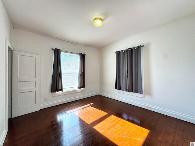 empty room featuring dark wood-type flooring