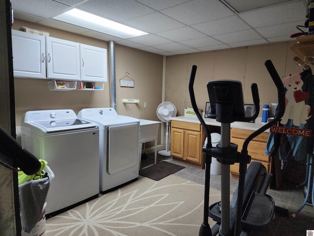 washroom featuring washing machine and dryer and cabinets