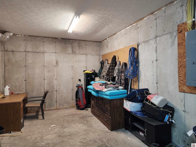 basement featuring electric panel and a textured ceiling