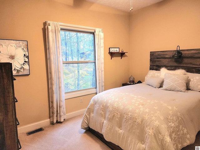 bedroom featuring light colored carpet