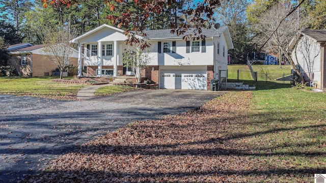 split foyer home with a front yard and a garage