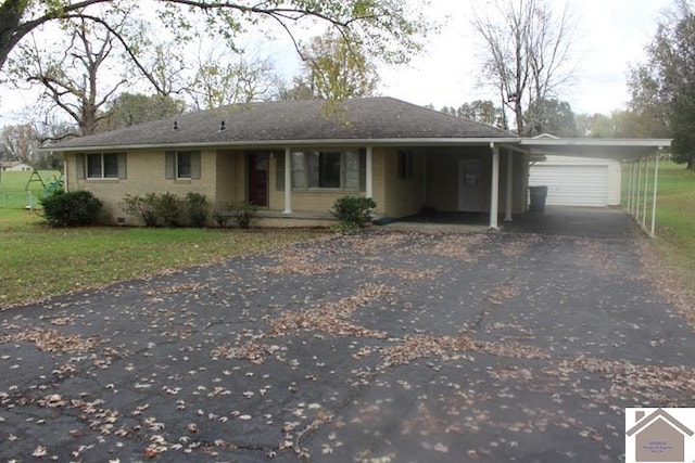 ranch-style house featuring a garage and a carport