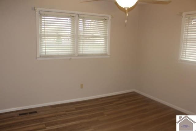 unfurnished room featuring ceiling fan and dark hardwood / wood-style flooring