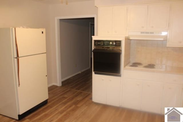 kitchen with backsplash, white cabinetry, hardwood / wood-style floors, and white appliances