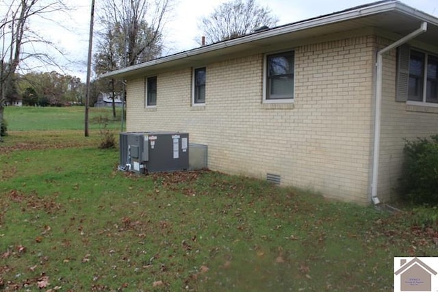 view of home's exterior featuring a lawn and cooling unit